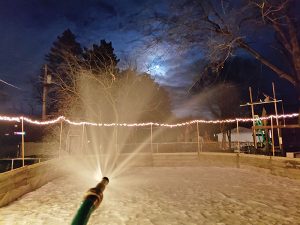 Hockey father, Lyle Mullenbach, spends cold winter Minnesota nights watering the ice rink in his backyard.  Photo submitted 