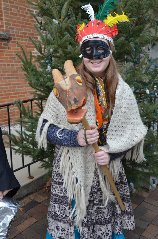 Younger, older and in-between appear in julebukking attire at Norwegian Christmas festivities at Vesterheim Museum. Note the traditional goat head with cord attached to make the mouth open and close.