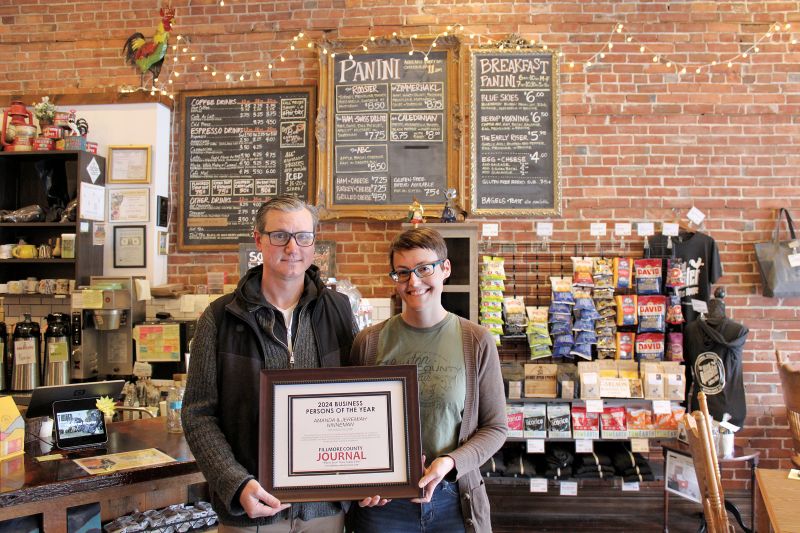 Amanda and Jeremiah Ninneman, owners of The Wired Rooster in Caledonia, Minn., stand in their coffee shop, holding their award of excellence compliments of Fillmore County Journal readers and staff. Photo by Jason Sethre