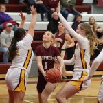 Gopher, Grace Schroeder has the ball as Pine Island surrounds her.