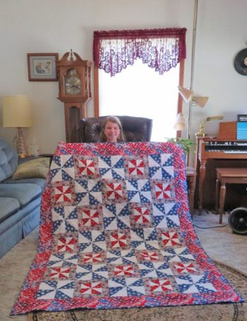Sydney Barth holding quilt