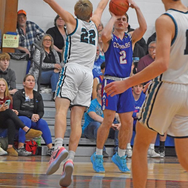 Tyler Larson shoots a three over Kyle Daniels