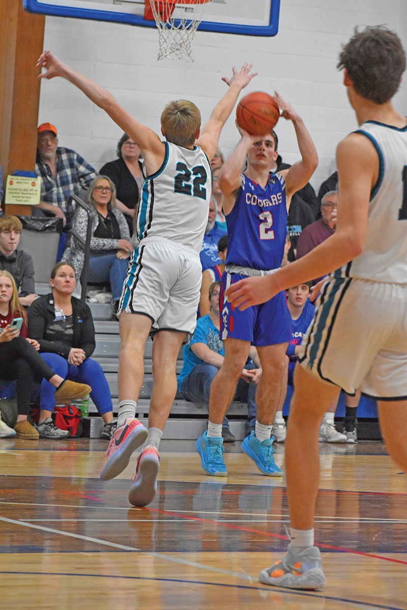 Tyler Larson shoots a three over Kyle Daniels