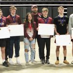 Chatfield's state wrestling qualifiers and their coaches pose for pictures after the 1A individual meet.