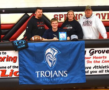 Spring Grove senior Ethan Crouch has signed to play college football at Dakota State in South Dakota. Observing from left is Spring Grove head coach Kody Moore and parents Sue and Jason Crouch. Photo by Lee Epps