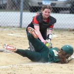 Spring Grove catcher Izabel Kaufmann completes an unassisted double play by tagging out Rushford-Peterson runner Torryn Schneider at home plate in the teams’ non-conference game