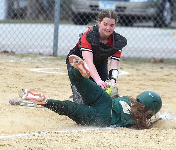 Spring Grove catcher Izabel Kaufmann completes an unassisted double play by tagging out Rushford-Peterson runner Torryn Schneider at home plate in the teams’ non-conference game