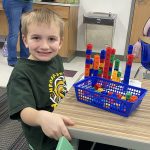 Noah B. counting and building towers with snap cubes. Photo submitted