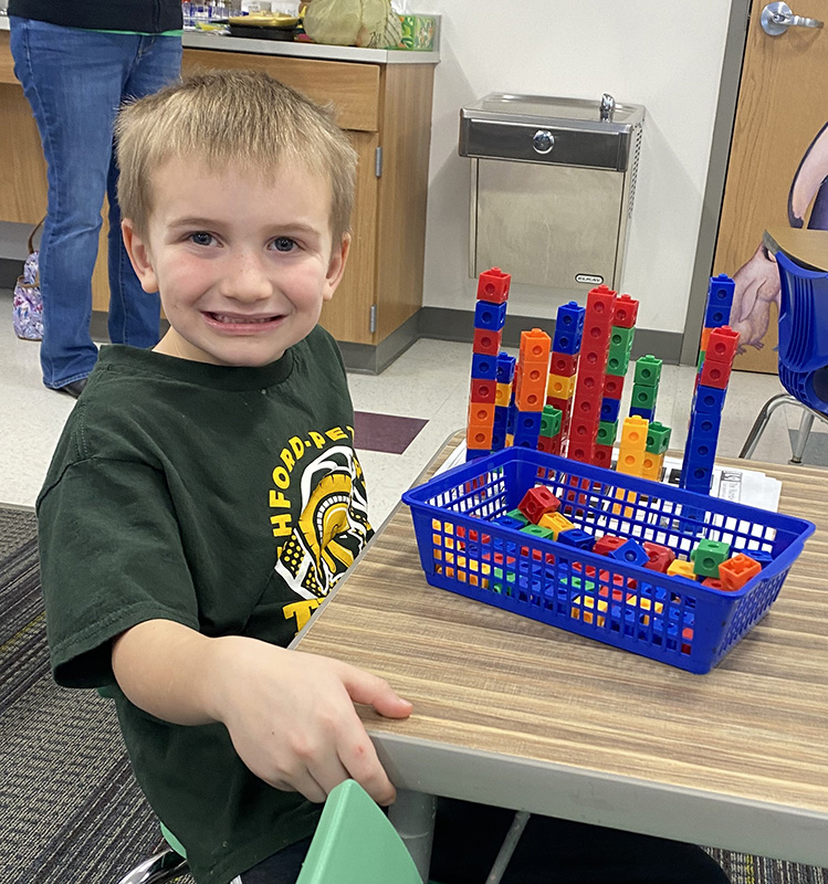 Noah B. counting and building towers with snap cubes. Photo submitted
