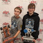 Joseph Lemke holds the winning robot while Jack Ingvalson holds the trophy.