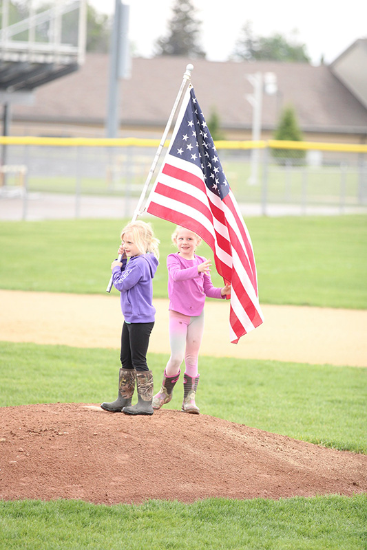 Kid with Flag on the Pitcher's Mound