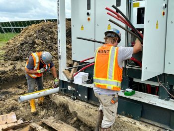 Workers install conduit