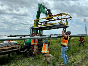 Workers installing panels