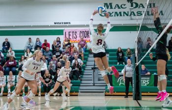 Harper Goldsmith floats as hitters Kylin and Jaelyn prepare to attack