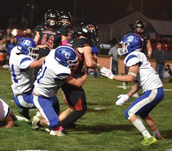 Mabel-Canton’s Milton Hutchinson brings down Spring Grove’s Bryce Berns in the teams’ SEC finale. But the Lions (7-0, 8-0) took care of the Cougars 40-16 to clinch a share of the South-East sub-district title with LeRoy-Ostrander/Lyle/Pacelli (7-0, 8-0). Photo by Lee Epps