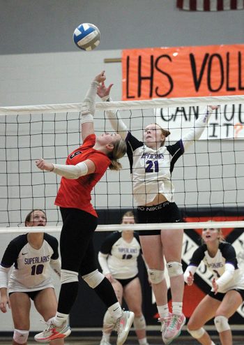 Lanesboro’s Jensyn Storhoff and Grand Meadow’s Gracie Foster battle at the net in the teams’ SEC finale. The Larks rallied from down a set to win in four, capturing the SEC-West title. Storhoff was honored before the match for her 1,000th career dig. Photo by Paul Trende