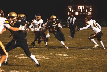 Fischer Wait takes a jet sweep around the corner, as teammate Tristan Meyer (#14) gets a block downfield. The #10 in AA Warriors (6-2) ended the regular season with a dominating 40-0 win over #9 in AAA Pine Island, as Caledonia is Section 1AA’s two-seed in the play-offs. Photo by Isaac Blocker