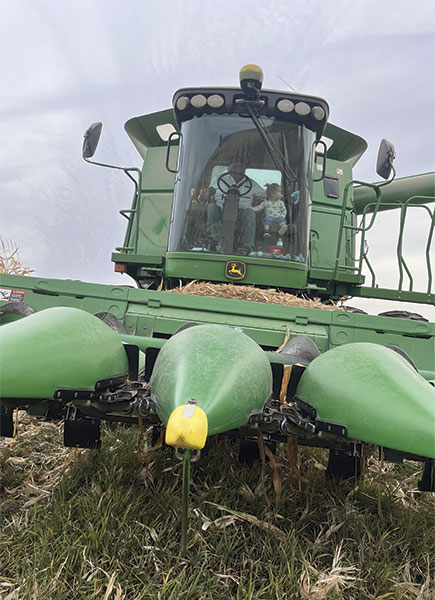 Granddaughter Remi’s first combine ride. Photo by Deb Knoepke