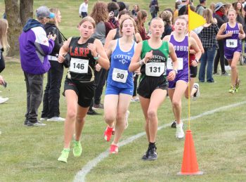 LARPH freshman Caitlin Bauer runs with Cotter/Hope Lutheran’s Emma Hatanpa and La Crescent/Hokah’s Aurora Kabat early in the Section 1A meet. Bauer finished 12th overall and was one spot away from earning an individual state berth. Photo by Paul Trende