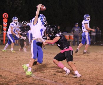 Mabel-Canton quarterback Isaac Underbakke is going to try to slip the tackle of Kingsland’s Parker Johnson, but it will be to no avail. Johnson got the sack, his 16th on the season, and the Knights blanked the Cougars in a 43-0 first round playoff win. Photo by Paul Trende