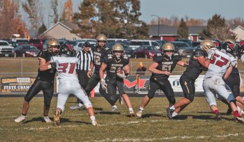 Caledonia’s Ben Stemper looks to take advantage of blockers in the #8 Warriors Section 1AA semifinal contest with Lewiston-Altura. Team Cal topped the Cardinals 20-12 to move on to a 1AA final with #2 in AA Chatfield. Photo by Isaac Blocker