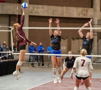 Chatfield senior Jaelyn LaPlante attacks with what will be the state-clinching kill over Winona-Cotter defenders Savy Repinski and Emily Blumers.