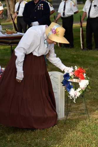 Donna Johnson, a member of Sons of Union Veterans of the Civil War (SUVCW) Camp 56 of Minnesota lays the wreath on the grave of Charles M. Culver. Photo by Charlene Corson Selbee