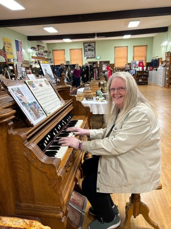 Shelley Jerviss plays the pump organ which was donated to the museum by the Catholic church. Photo by Wanda Hanson