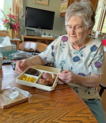 Rose Smith shows her meal for the day – meatballs, baked potato, corn and a cherry brownie along with bread and milk. Photo by Wanda Hanson