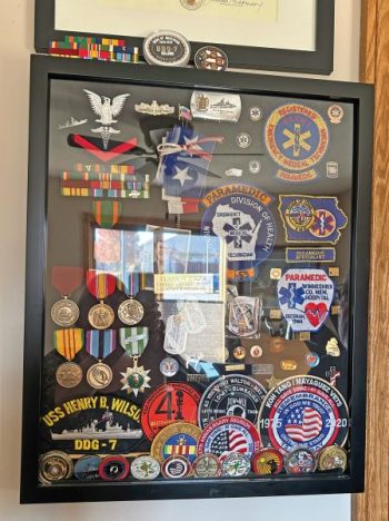 Clark with his displayed medals and awards. Photo by Wanda Hanson