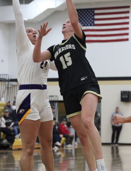 Caledonia’s Nicole Banse takes the ball to the hoop against Rochester-Lourdes’ Liliana Davick in the teams’ season-opener. A rematch of last year’s 1AA semis saw the Warriors notch a controlling 67-48 win over the defending 1AA champs. Photo by Paul Trende