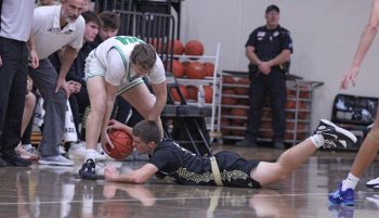 Caledonia’s Mason King dives on the floor for a loose ball at the feet of La Crescent/Hokah’s Mayes Boyer. The #2 in Class AA Warriors’ week included wins over the Lancers and Fillmore Central, but a loss at Wisconsin D-II #8 Onalaska.