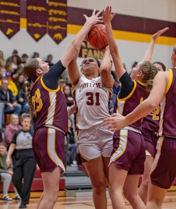 Chatfield’s Amaya Harmening fights through the interior congestion of Dover-Eyota’s Abby Griebenow (left) and Jayda Davis (right) in the teams’ early season TRC match-up, a 62-50 Eagle win. Photo by Leif Erickson