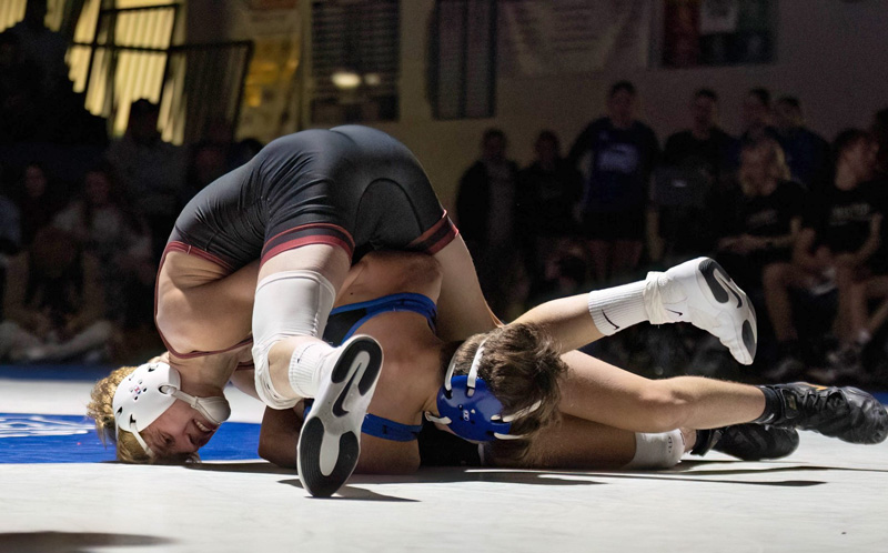 Chatfield’s Kaisen Johnson works to try to turn Kasson-Mantorville’s Noah Cocker at 133-pounds. Johnson posted a 17-1 tech fall win as part of Chatfield’s 35-19 team victory.