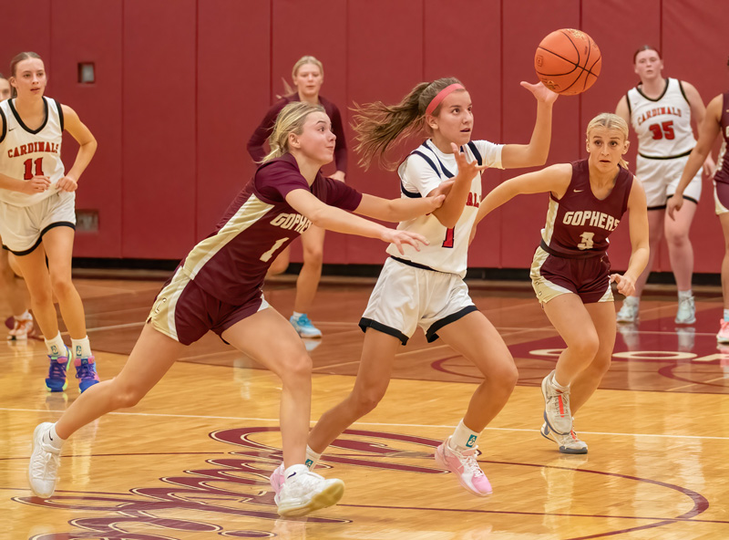 Chatfield’s Grace Schroeder (left) and Brittin Ruskell (right), Lewiston-Altura’s Maycie Mierau, all eye the play in the teams’ TRC match-up. Mierau had a game-high 34 points but Chatfield prevailed 65-52.