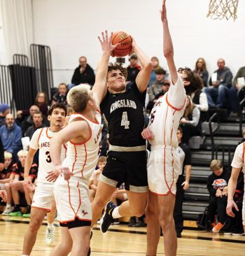 Kingsland’s Parker Johnson powers his way to the bucket, trying to offset the notable height of Lanesboro’s 6’7” Jackson Taylor. Johnson and the Knights posted a 55-38 SEC victory over the Burros.