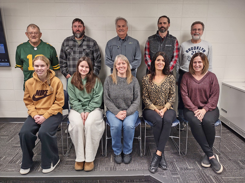 At the last meeting for Daniel Small as a school board member, back row, left to right: Spencer Yohe, Derek Adamson, Tim Gunn, Mike Peterson, and Small. Front row: Student School Board representatives Addie Fruechte and Samantha Peters, Melissa Marschall, Julie Augedahl (new board member), and Leigh King.