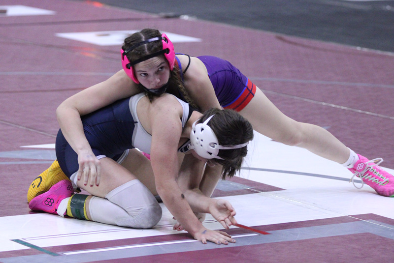 GMLOS’ Brandy Christenson works from the top position in her semifinal bout at the prestigious Bi-State girls tourney. The sophomore went 4-0 to break new ground, claiming GMLOS’ first ever Bi-State gals individual title, doing so at the 30-gal, 114-pound weight class. Photo by Paul Trende