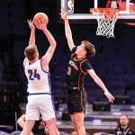 Lanesboro’s Aedan Flaby contests the shot of Grand Meadow’s Logan Grafe in the teams’ non-conference affair at the Target Center. Part of a boys/girl’s doubleheader, the Burros got the win 43-36. Photo by Ron Mayer