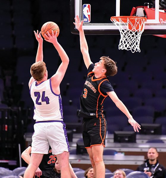 Lanesboro’s Aedan Flaby contests the shot of Grand Meadow’s Logan Grafe in the teams’ non-conference affair at the Target Center. Part of a boys/girl’s doubleheader, the Burros got the win 43-36. Photo by Ron Mayer