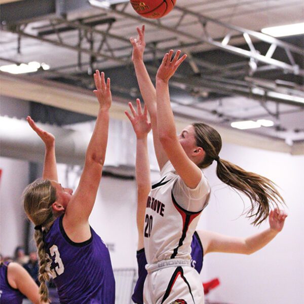 Spring Grove’s Kylie Hammel shoots over Grand Meadow’s Naomi Warmka in the teams’ SEC game for first place. The Lions ended on a 24-5 run to erase a 44-35 deficit and post a 59-49 win, grabbing sole possession of the top spot in the league. Photo by Paul Trende