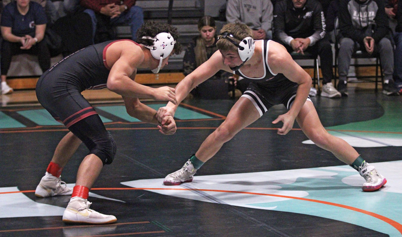 State-ranked guys Javier Berg (#4) of Chatfield and Christian Zibrowski (#3) of LARP feel each other out early in their 121-pound final at FCLMC’s holiday wrestling tourney. Berg (8-0) pinned Zibrowski (11-1) on his way to a second tournament Most Outstanding Wrestler award. Photo by Paul Trende