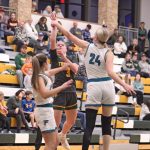 Rushford-Peterson’s Emily Helgemoe sends up the floater most notably over Fillmore Central’s Sophia Bronner (#24) at the Trojans’ holiday tourney. R-P beat the Falcons 58-34 to sweep the season series. Photo by Paul Trende