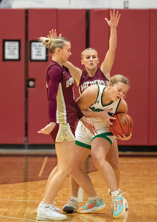 Chatfield’s Grace Schroeder (left) and Brittin Ruskell (right) trap La Crescent/Hokah’s Charlee Gile in the teams’ TRC affair. Schroeder scored a game-best 23 points in a 55-37 Gopher win. Photo by Leif Erickson