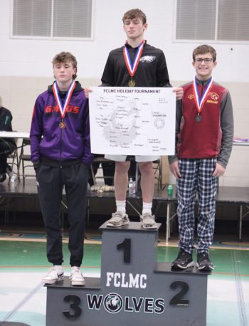 LARP’s Owen Lange (13-0 on the year) tops the podium after winning the 127-pound weight class at FCLMC’s holiday wrestling tourney. GMLOS’ Parker Armagost (left), who took third, is also pictured. Photo by Paul Trende