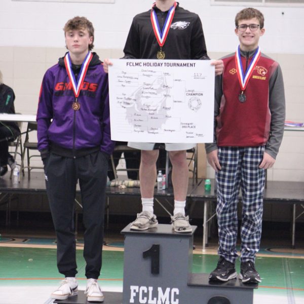 LARP’s Owen Lange (13-0 on the year) tops the podium after winning the 127-pound weight class at FCLMC’s holiday wrestling tourney. GMLOS’ Parker Armagost (left), who took third, is also pictured. Photo by Paul Trende