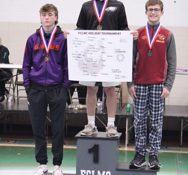 LARP’s Owen Lange (13-0 on the year) tops the podium after winning the 127-pound weight class at FCLMC’s holiday wrestling tourney. GMLOS’ Parker Armagost (left), who took third, is also pictured. Photo by Paul Trende
