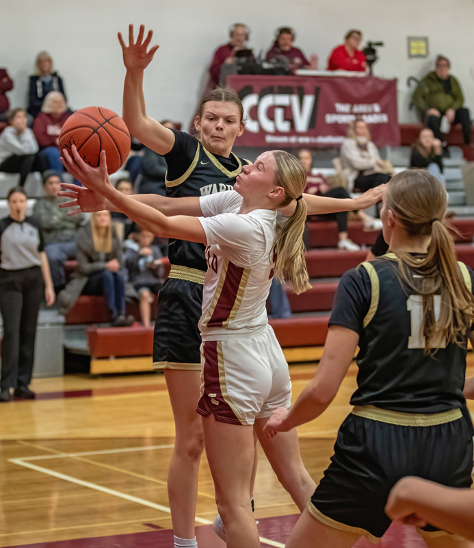 Chatfield’s Lexi Kivimagi swoops to the hoop as Caledonia’s Josie Foster eyes the blocked shot in the teams’ TRC matchup. Highlighted by Aubrie Klug topping 1,000 career points, the Warriors won handily 76-45. Photo by Leif Erickson