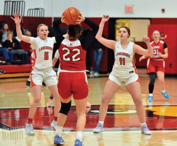 LeRoy-Ostrander’s Benita Nolt looks for a pass against the double-team defense of Lanesboro’s Emma Ruen (left) and Jentrey Schreiber (right). The Burro girls downed Kingsland 67-54 and the Cards 60-48 on the week to improve to 7-5 on the season. Photo by Ron Mayer