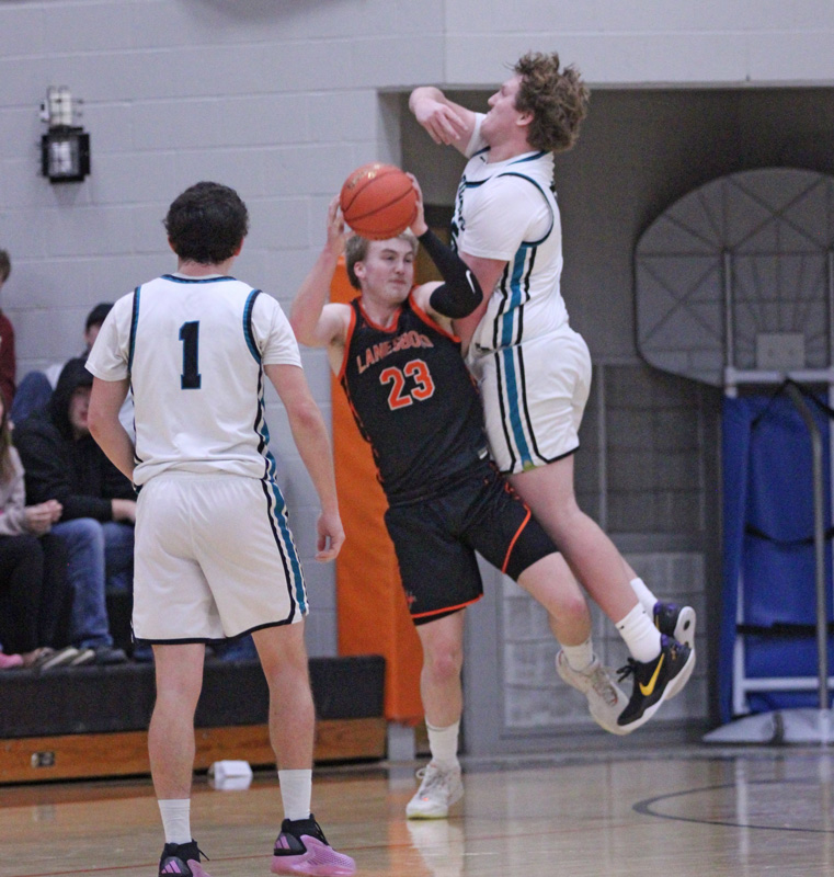 Lanesboro’s Levi Rogers got popped good, and fouled by 6’5” 280-pound Tyler Gulbranson of Fillmore Central. In a backyard double-header battle of rivals, the Falcon boys and girls posted wins, 65-55 (boys) and 63-55 (girls). Photo by Paul Trende